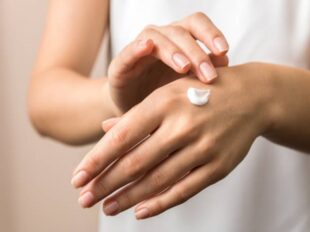 skincare. close up view of woman hand moisturising them with cream. skincare.